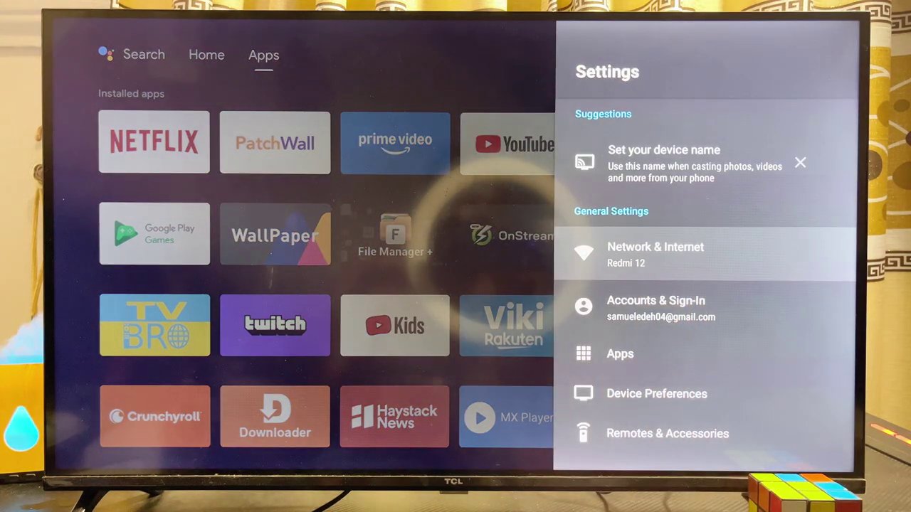 An Android TV home screen showing a Wi-Fi connection to a mobile hotspot named "redmi 12".