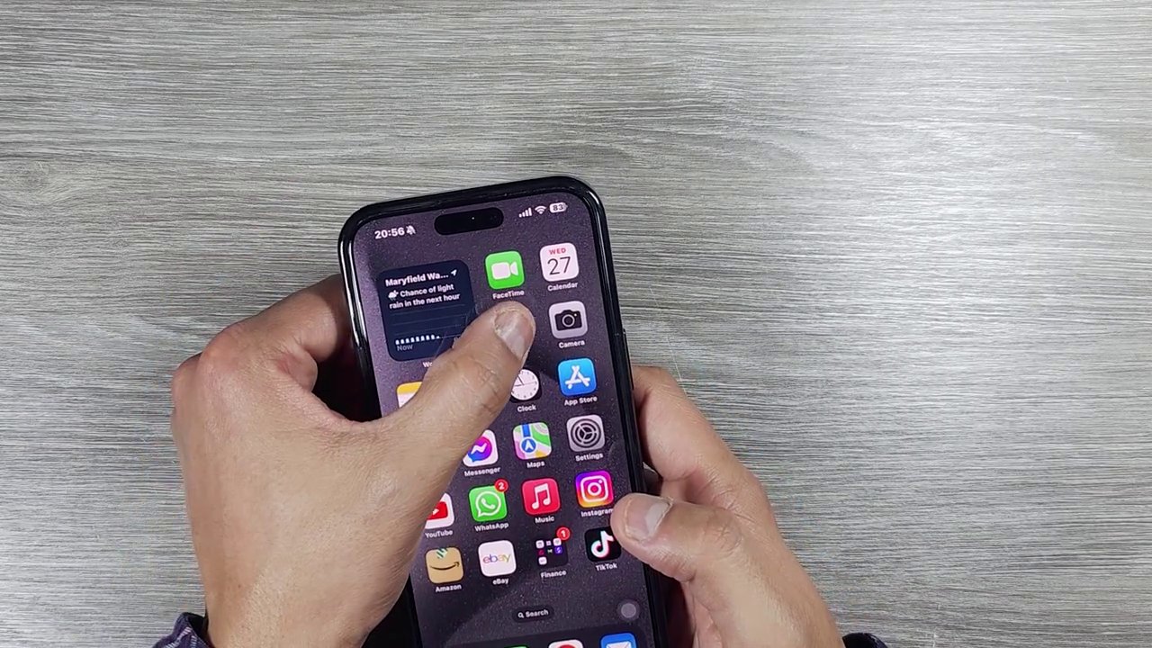 The iPhone screen displaying a download progress bar while the shortcut processes the Instagram Reel.
