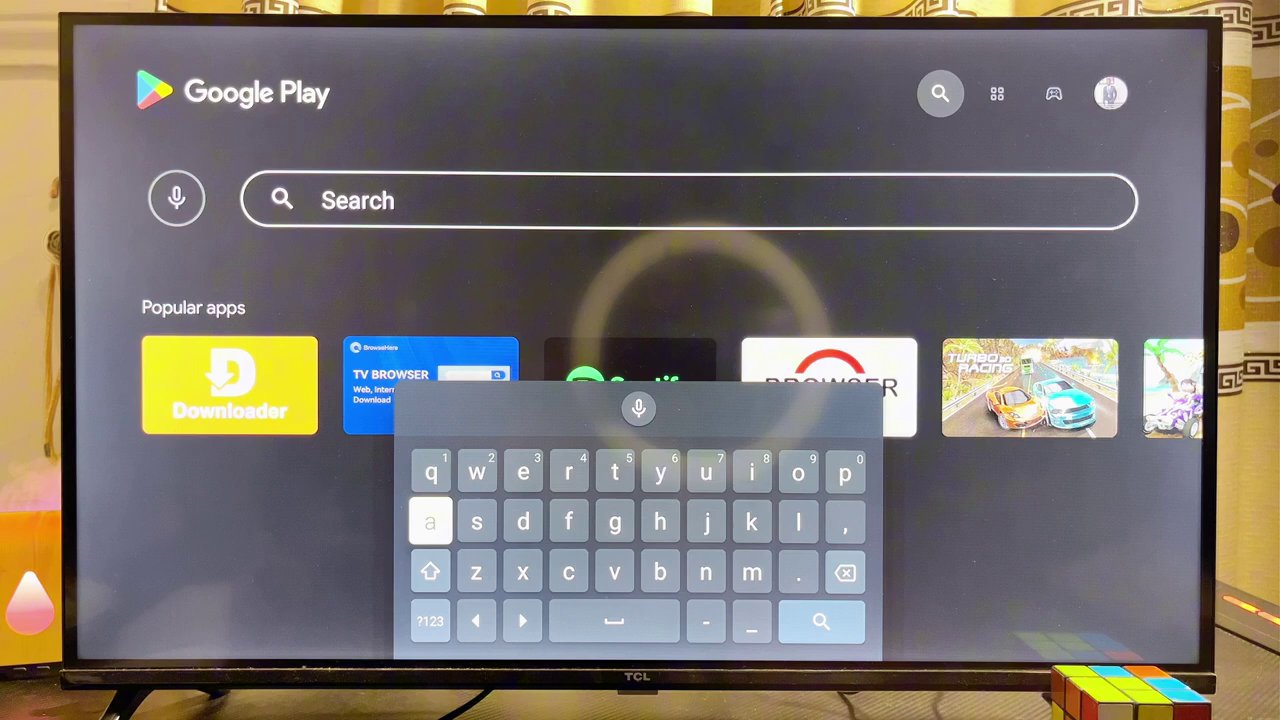 The Google Play Store search results on Android TV showing the "Downloader" app by AFTVnews.