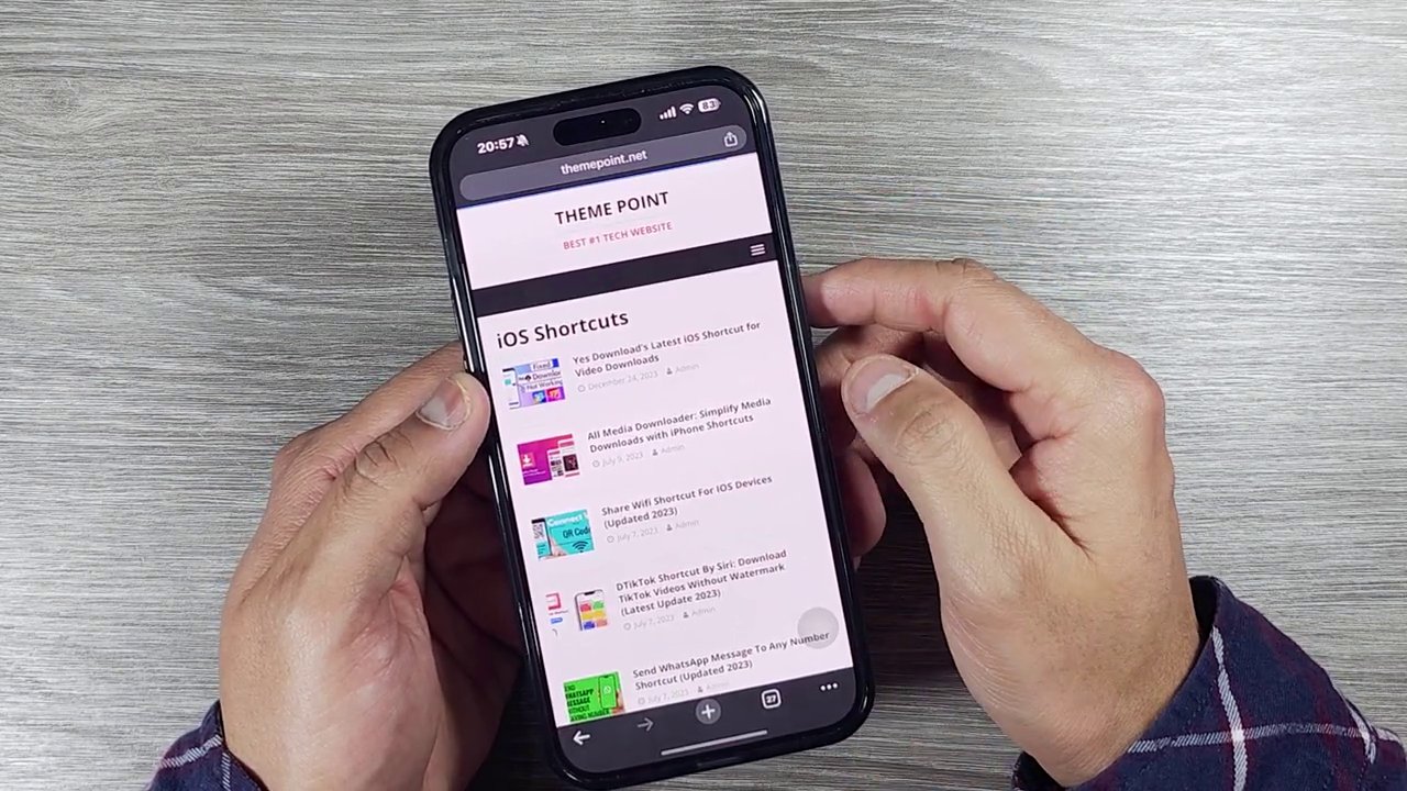 A close-up of the iPhone screen showing the "Install Shortcut" button in red on the theme point website.